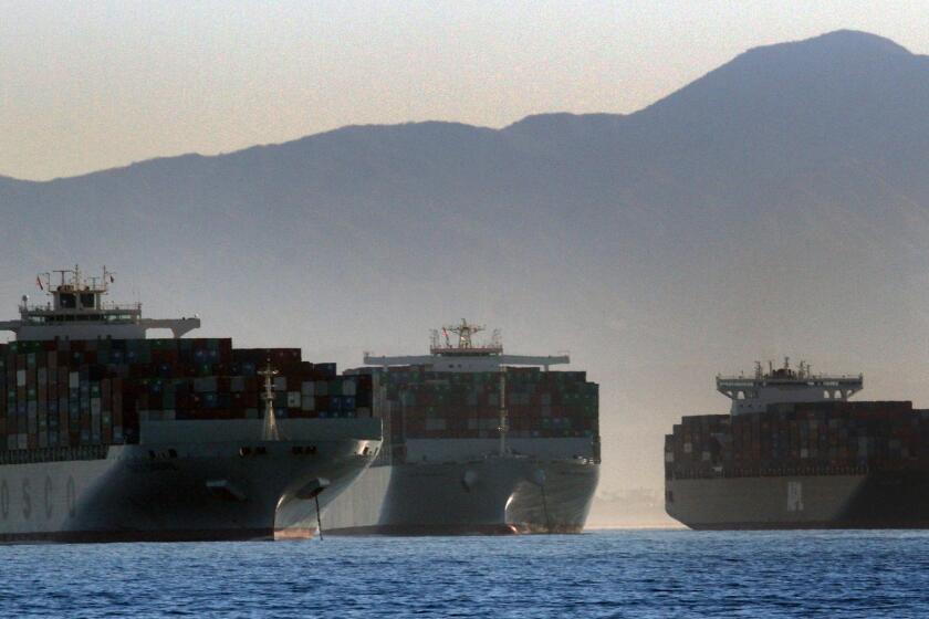 Three container ships wait to get into the ports of Los Angeles and Long Beach on Wednesday.