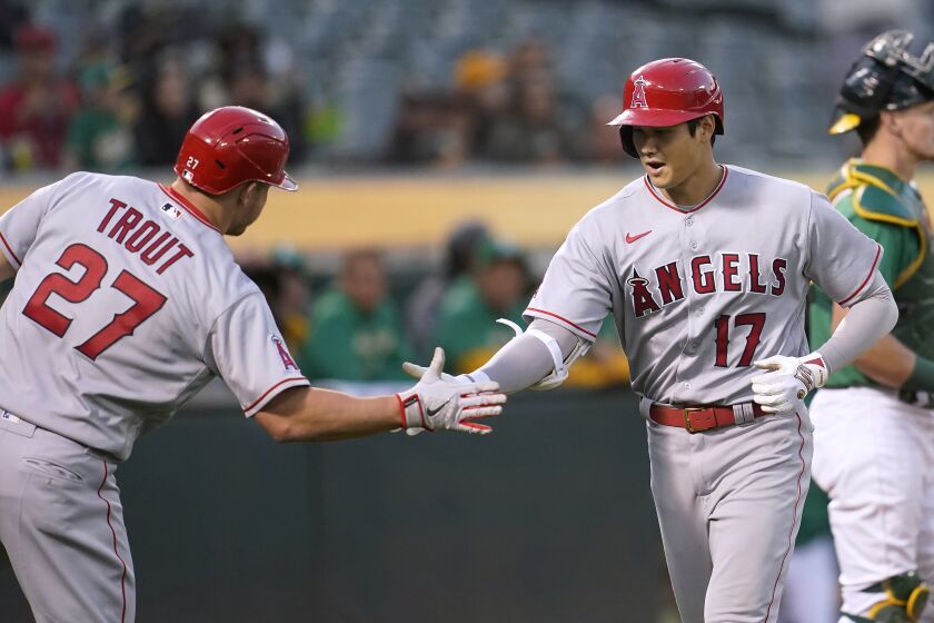 The Angels' Shohei Ohtani (17) is congratulated by Mike Trout after Ohtani hit a fifth-inning homer May 14, 2022.