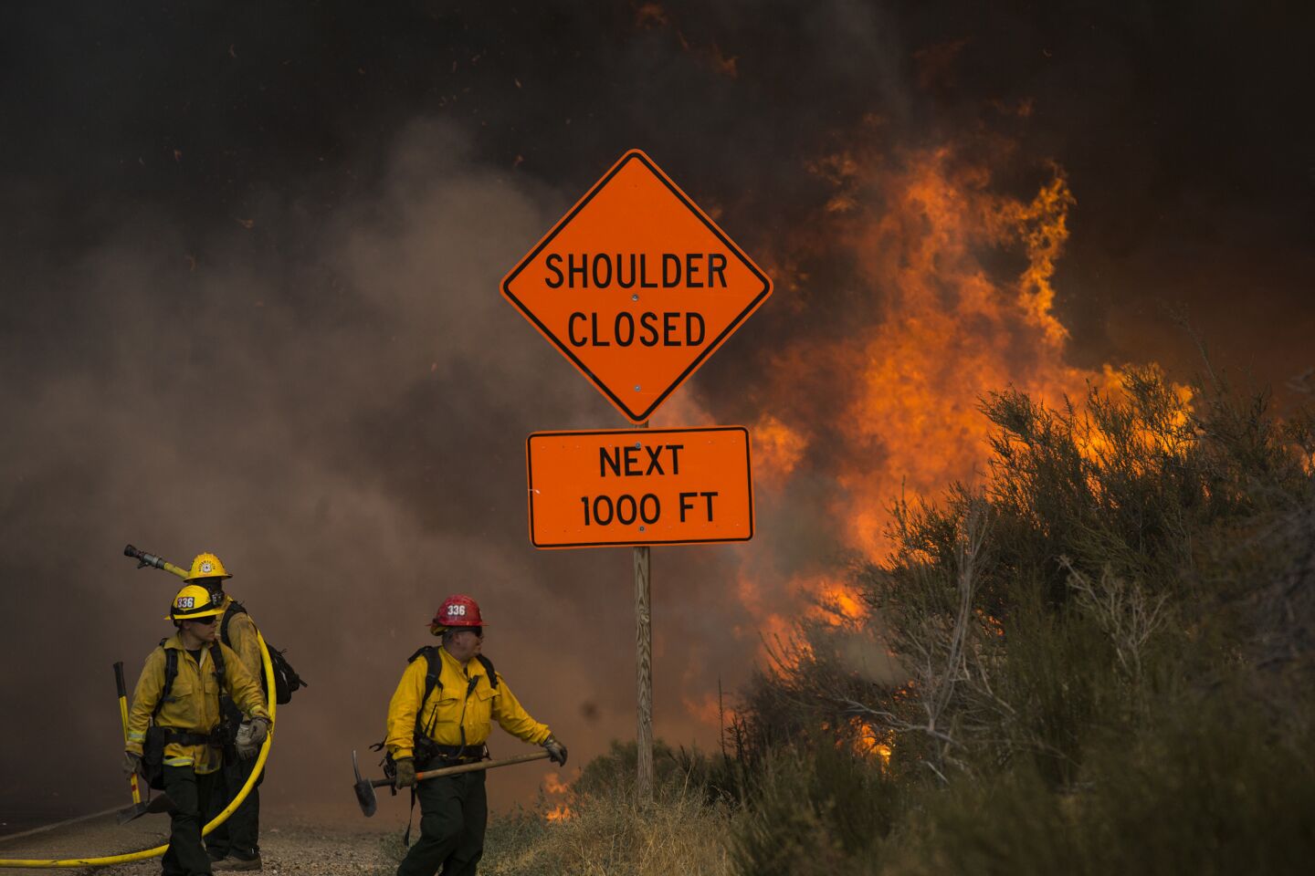 Fire crews attempts but can not stop the Blue Cut fire as it spreads along Highway 138 in Phelan, California.