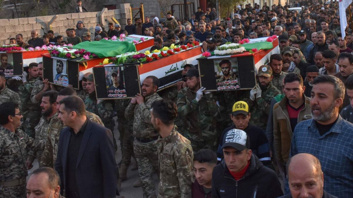Iraqi paramilitary members carry the coffins of fellow fighters during a funeral Thursday in their hometown of Tuz Khurmatu. They were killed a day earlier in an ambush outside Mosul.