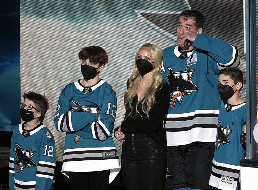 FILE - San Jose Sharks center Patrick Marleau (12) wipes away tears as he was honored for his 1,768 NHL games played, before the team's hockey game against the Minnesota Wild on Saturday, April 24, 2021, in San Jose, Calif. With Marleau are his wife, Christina, and children. Marleau announced his retirement Tuesday, May 10, 2022, following a 23-year career in the NHL.(AP Photo/Tony Avelar, File)