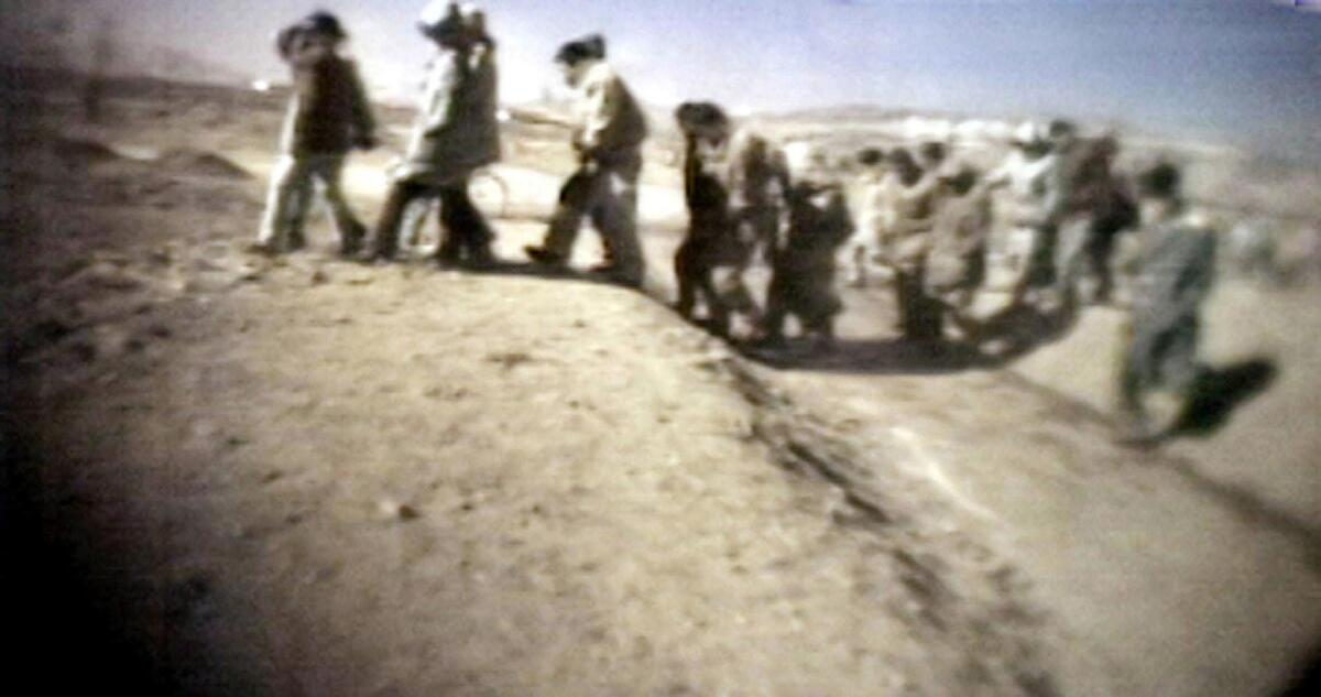 This image from an unverified video apparently showing North Korean prisoners heading to a public trial aired on Japanese television in March 2005. The network claimed to have obtained footage of two public executions in North Korea from people inside the country.
