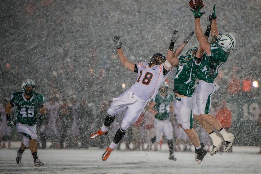Dartmouth football player Garrett Waggoner, right, intercepts a Princeton pass in a game last month. A new study in Neurology finds that Dartmouth athletes who played football and ice hockey had measurable brain injuries even when they didn't suffer concussions.