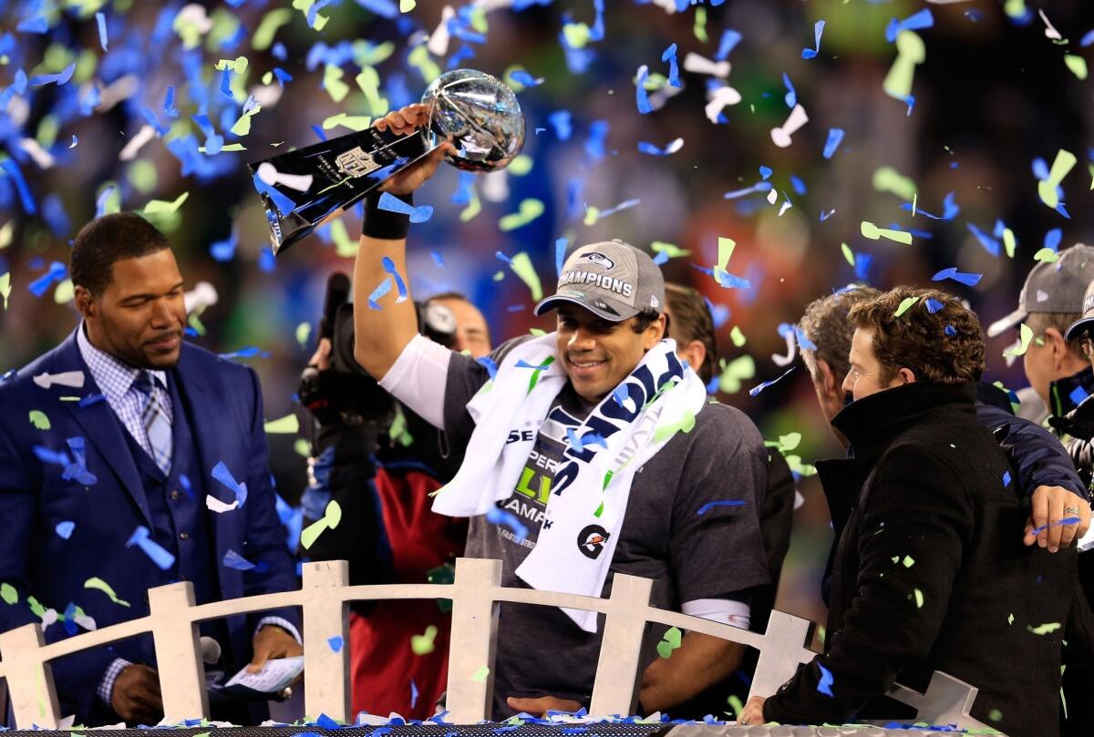 Russell Wilson of the Seattle Seahawks celebrates with the Vince Lombardi trophy.