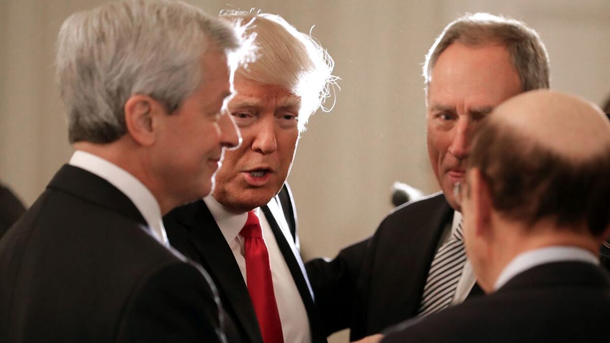 JPMorgan Chase CEO Jamie Dimon, left, powwows with President Trump and other guests during a CEO meeting at the White House in February. The CEO council hasn't met in months.