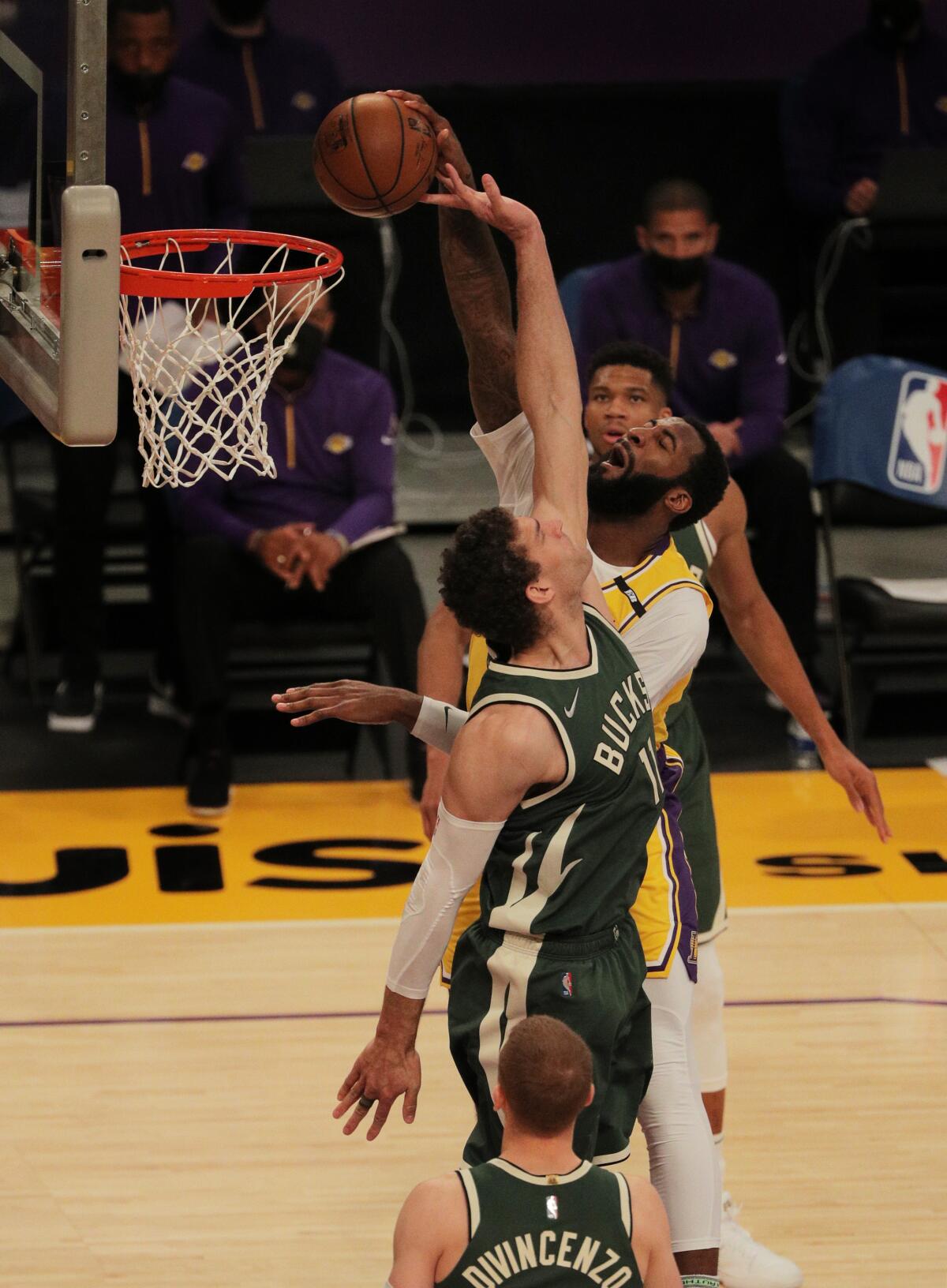 Lakers Andre Drummond tries to dunk over Milwaukee Bucks center Brook Lopez.