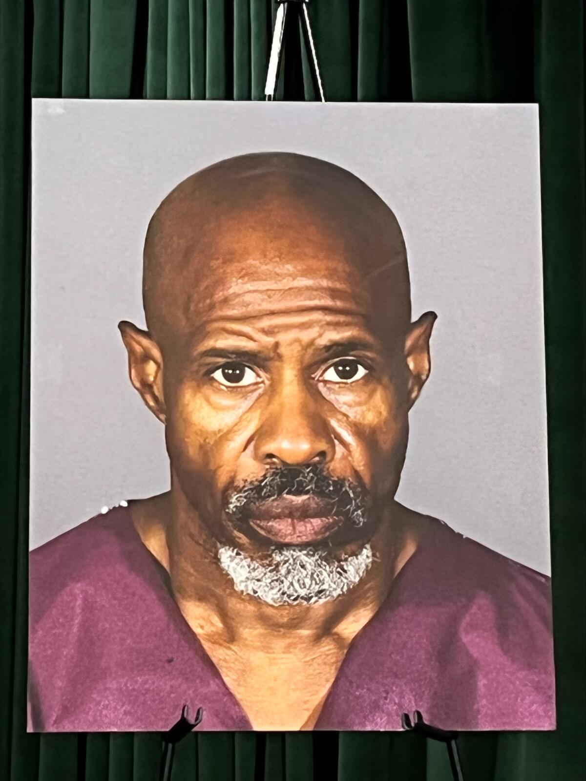 A man's enlarged photograph is seen sitting on an easel at a news conference.