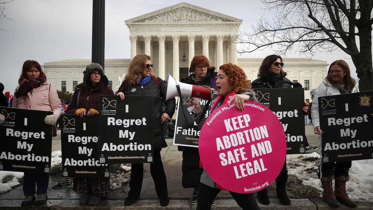 Protesters on both sides of the abortion debate gather in front of the Supreme Court building during the Right To Life March in Washington on Jan. 18.