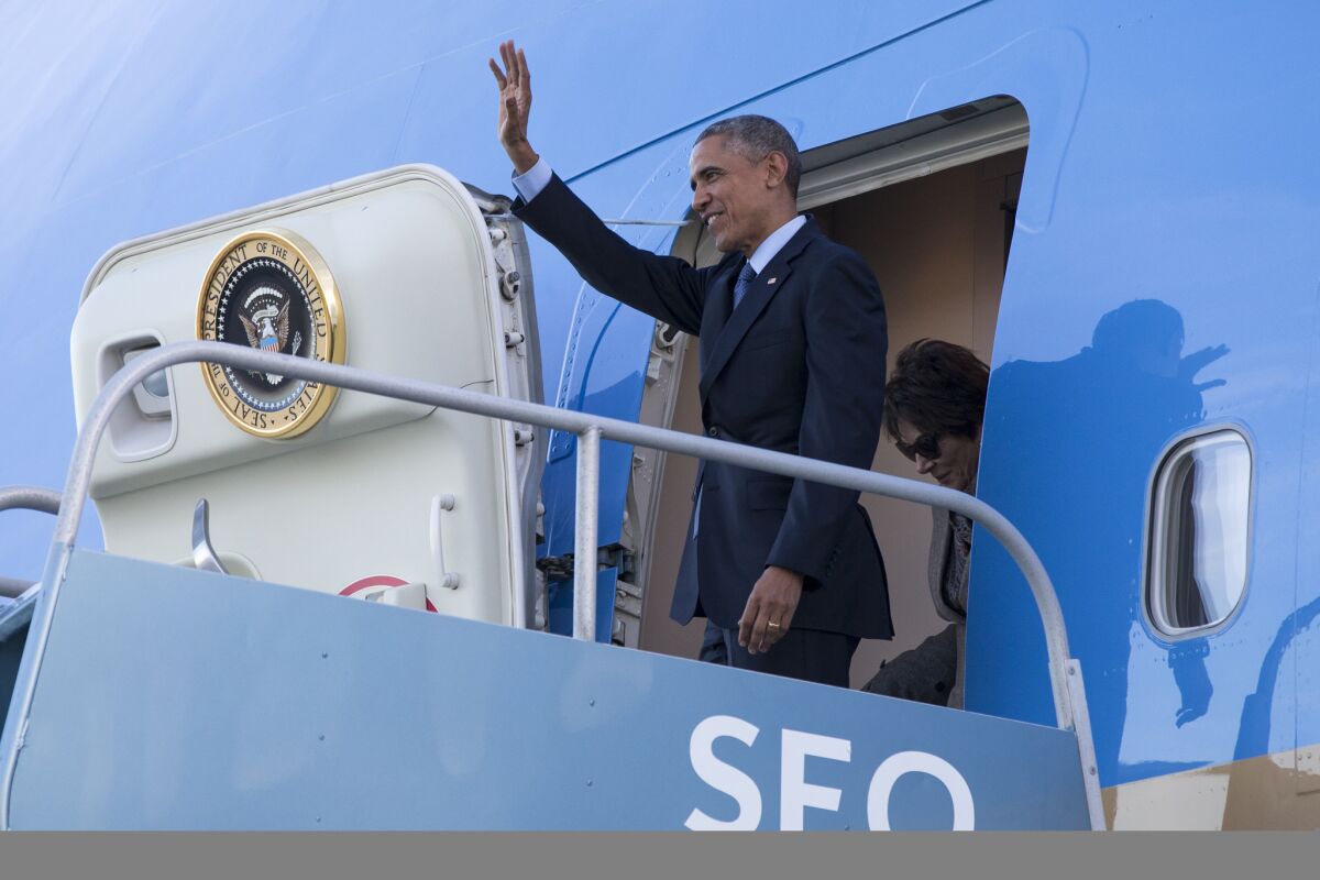 President Obama waves after arriving at San Francisco International Airport on a fundraising trip on Feb. 12.