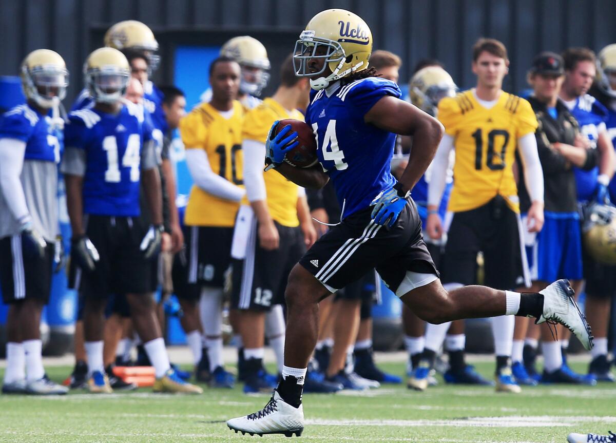 UCLA running back Paul Perkins works out during the Bruins' spring practice opener.