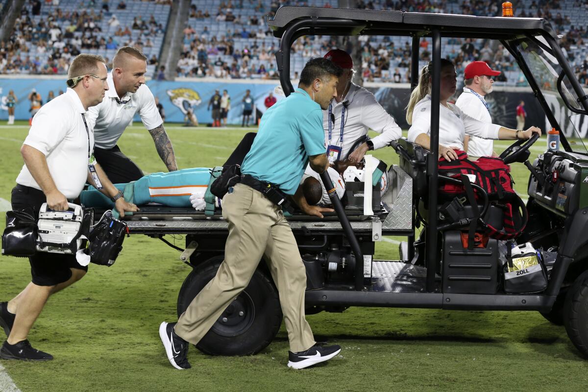 Daewood Davis of Dolphins carted off field after collision; preseason game  vs. Jaguars halted