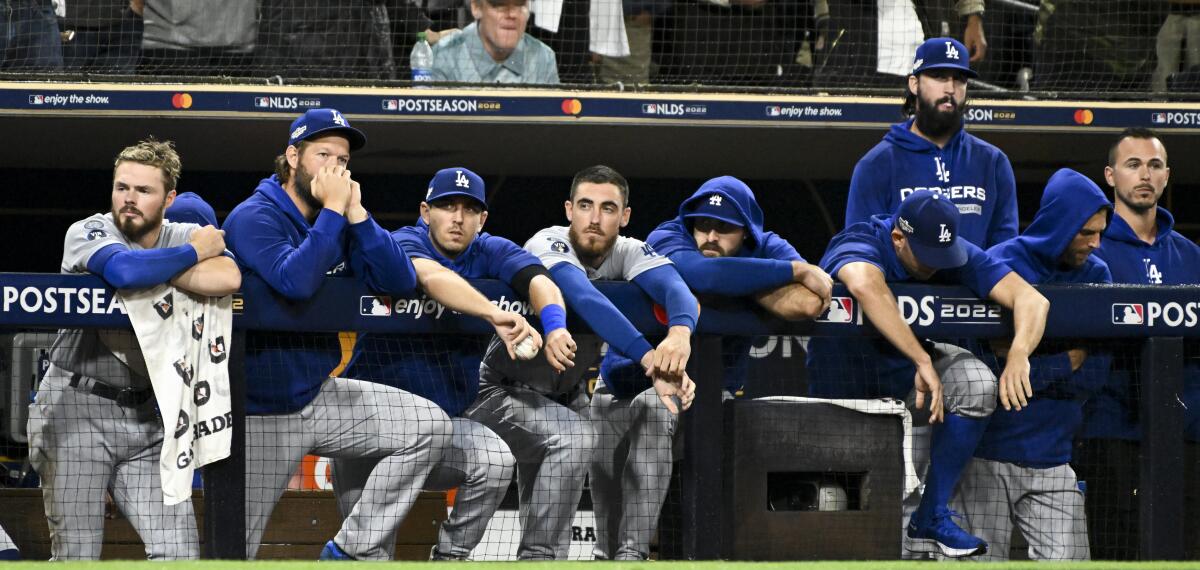 Dodgers players watch in the dugout during the ninth inning of Game 4 of the NLDS at San Diego on Oct. 15, 2022.