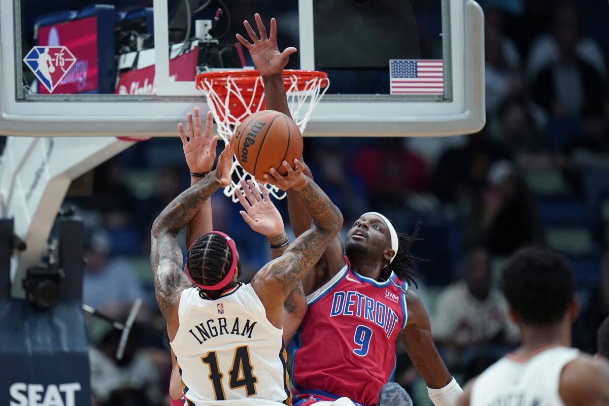 Pistons forward Jerami Grant tries to block a shot by Pelicans forward Brandon Ingram.
