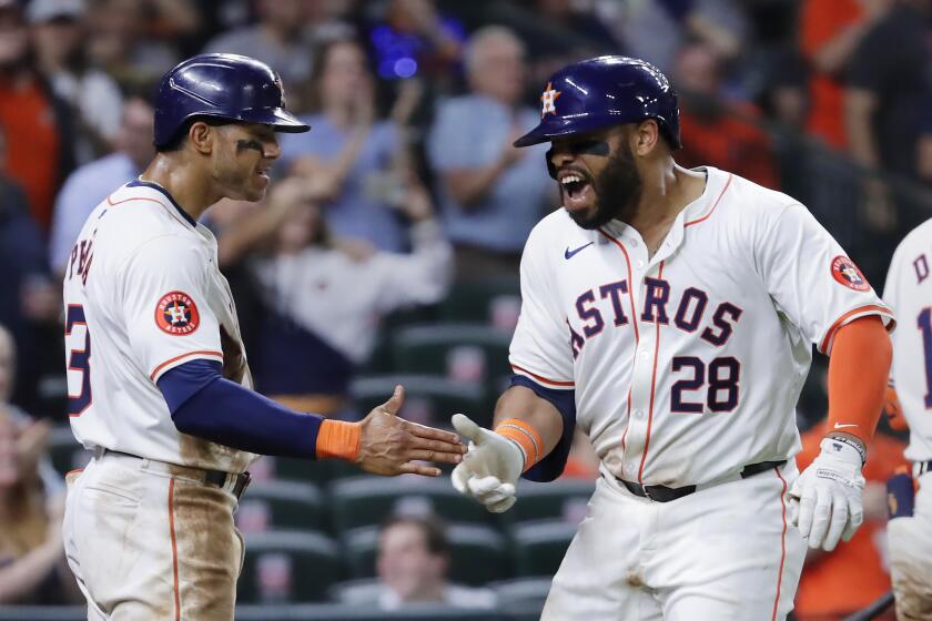 Houston Astros' Jeremy Pena, left, and Jon Singleton (28) celebrate after they scored on a two-run home run by Singleton against the Cleveland Guardians during the sixth inning of a baseball game Thursday, May 2, 2024, in Houston. (AP Photo/Michael Wyke)