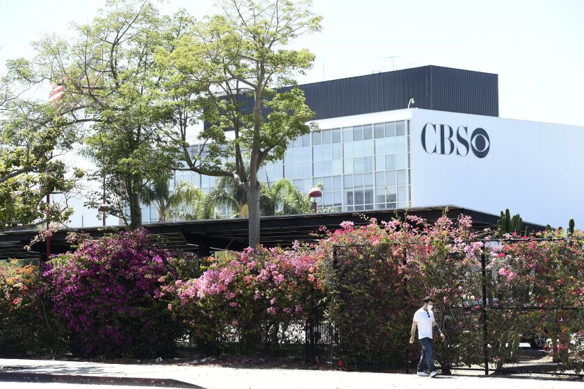 A pedestrian walks by the CBS Television City studios, Friday, July 3, 2020, in Los Angeles. (AP Photo/Chris Pizzello)