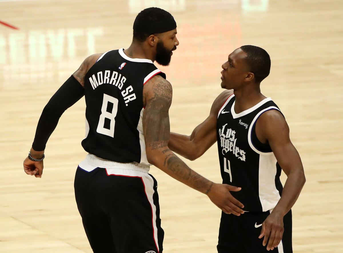Clippers teammates Marcus Morris Sr., left, and Rajon Rondo react during Sunday's win over the Lakers.
