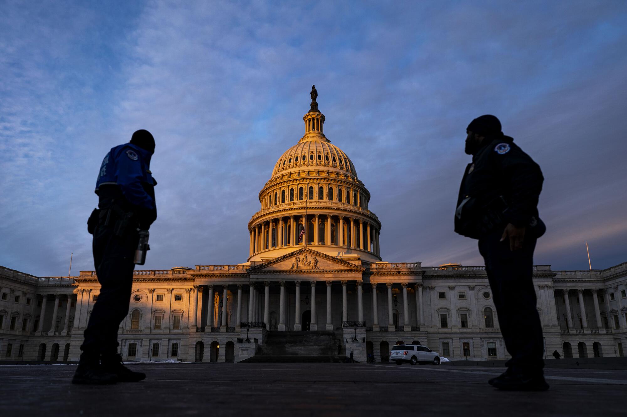 Capitol Police officers outside the Capitol in the early morning light