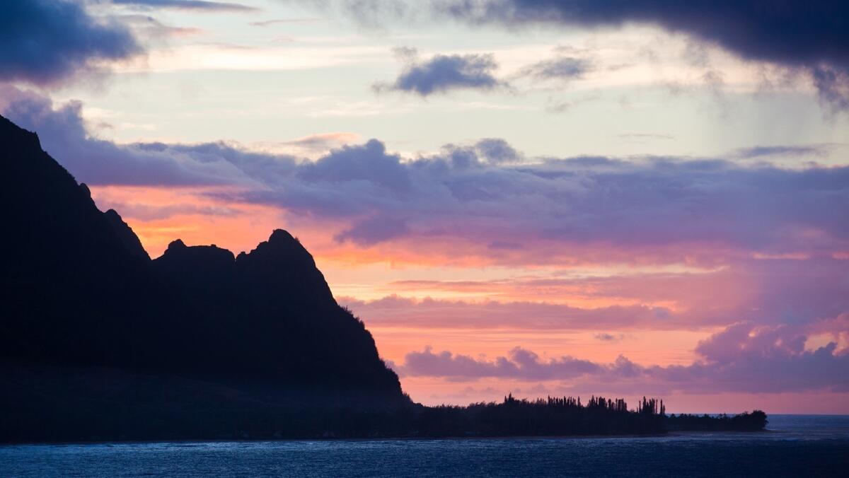 Glorious sunsets, such as this one behind Hanalei Bay, are just one of many attractions on the island of Kauai.