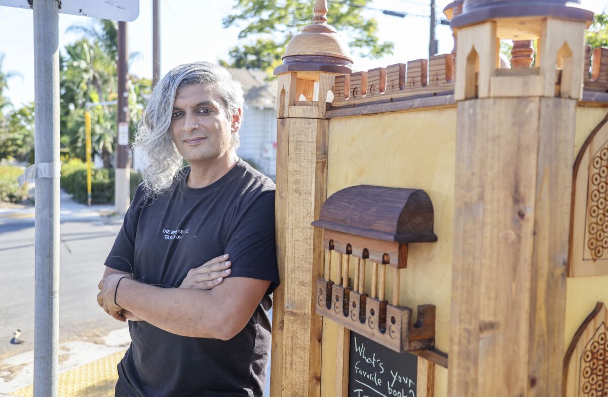 Kazim Ali photographed with a  Little Free Library in Normal Heights
