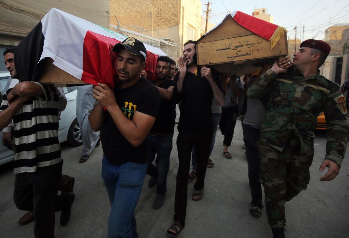 Iraqis carry the coffins of relatives on Sept. 6, 2016, a day after a deadly car bomb explosion in the Karada district of the capital, Baghdad.