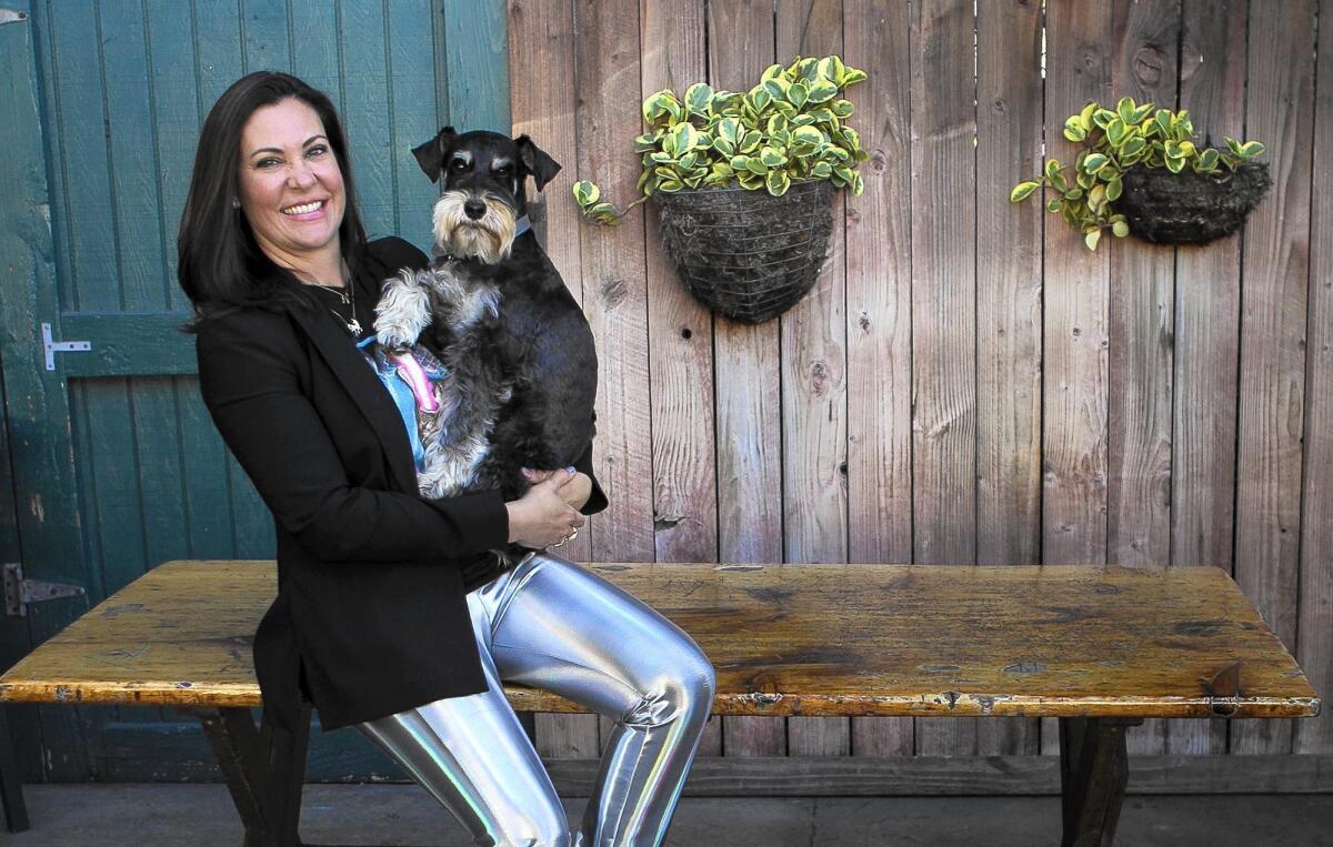 Carrie Cramer, the owner of Carrie Cramer Jewelry, with her dog Atticus, a 5-year-old schnauzer.