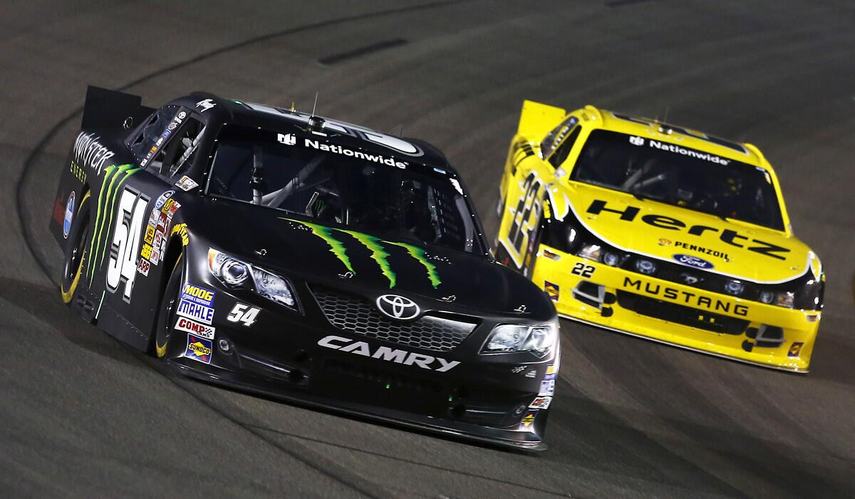 NASCAR driver Kyle Busch, in the No. 54 Toyota, leads Ryan Blaney during the Nationwide Series race on Friday night at Richmond International Raceway.