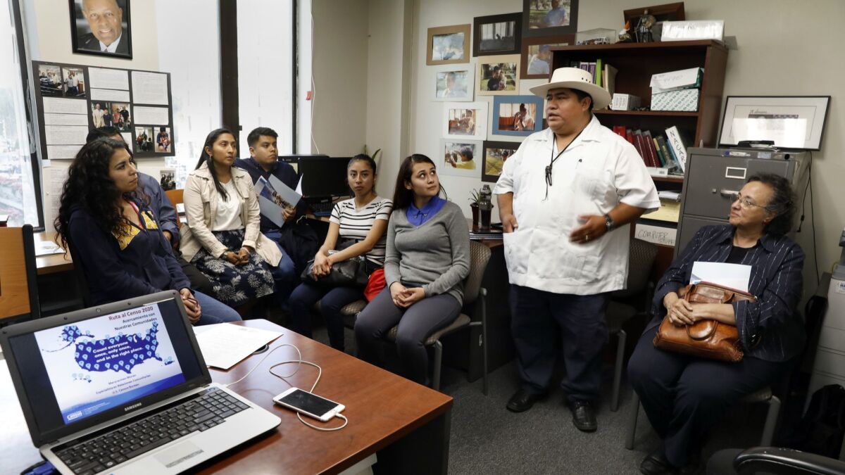 Policarpo Chaj, second from right, director of Maya Vision, speaks to a group of Mayan community members during a 2020 census meeting at Centro Cultural Techantit.