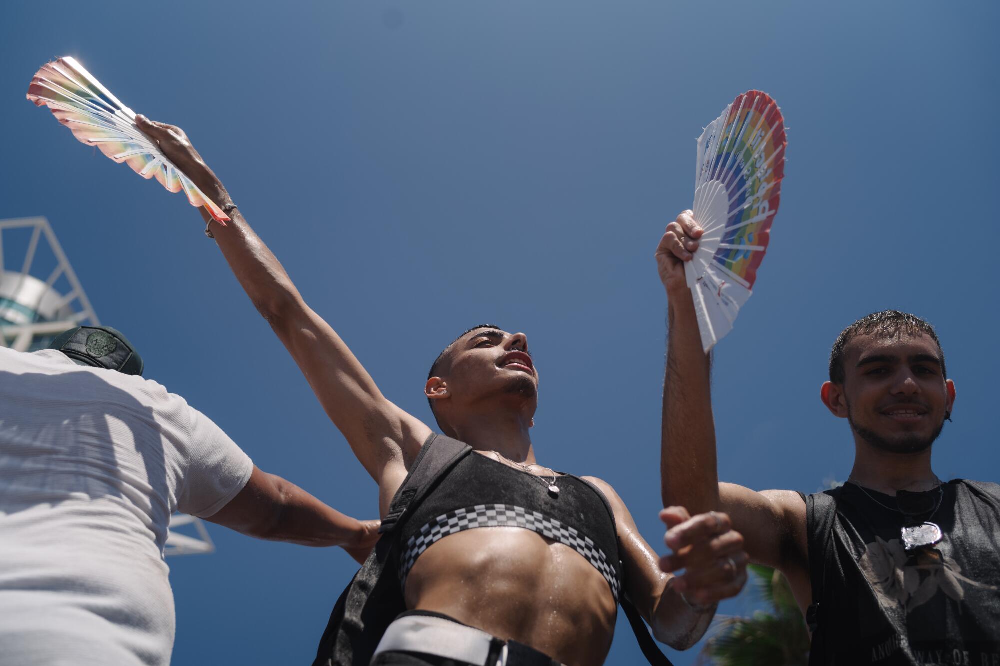 Pride parade attendees dance on a platform along the beach in Tel Aviv