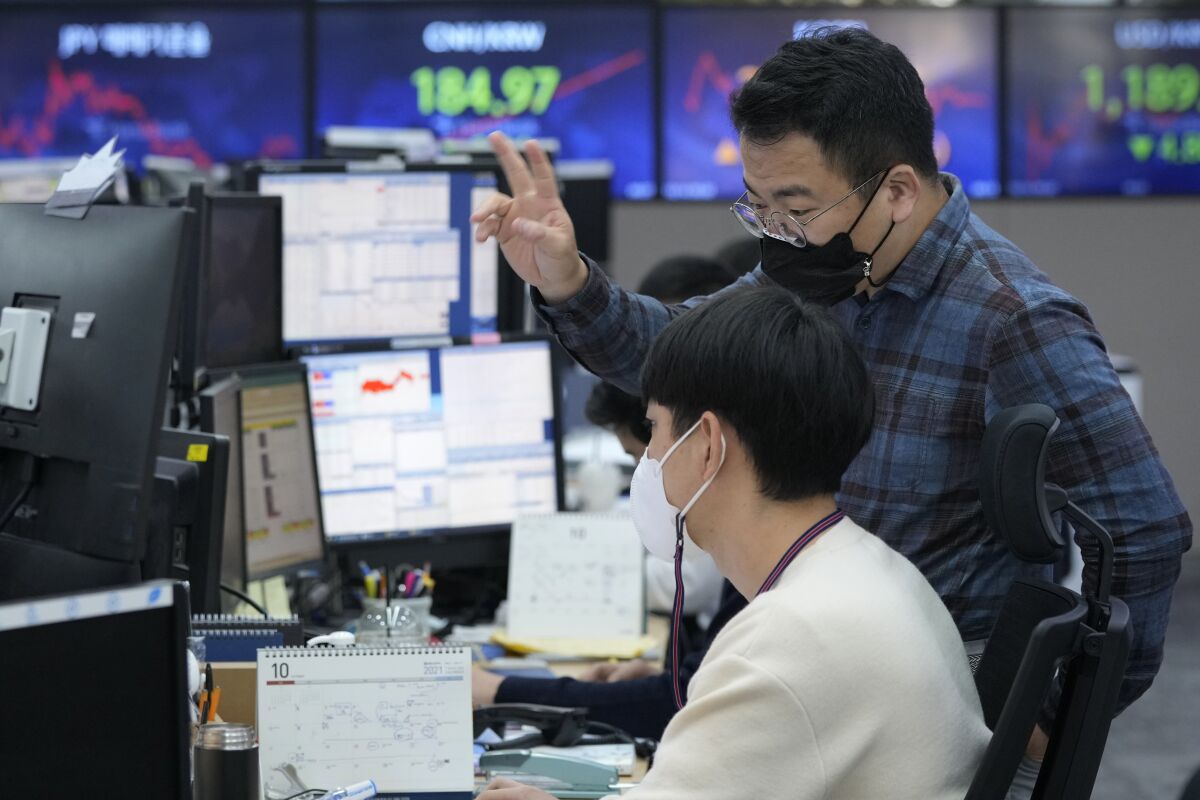 Currency traders watch monitors at the foreign exchange dealing room of the KEB Hana Bank headquarters in Seoul, South Korea, Thursday, Oct. 14, 2021. Asian shares were mostly higher on Thursday, tracking an overnight rally on Wall Street as investors sought out bargains, including technology stocks. (AP Photo/Ahn Young-joon)