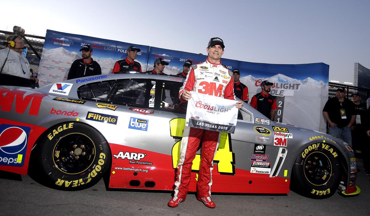 Jeff Gordon poses for photos after winning the pole position for Sunday's NASCAR Sprint Cup Series auto race in Las Vegas.