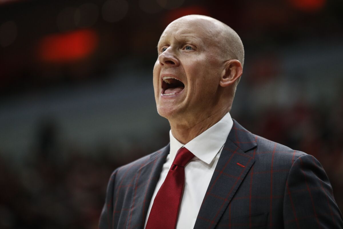 FILE - Louisville head coach Chris Mack yells to his players during the second half an NCAA college basketball game against North Carolina in Louisville, Ky., in this Saturday, Feb. 22, 2020, file photo. The NCAA has amended its Notice of Allegations against Louisville, adding additional violations committed by the men’s basketball program that include impermissible activities and accusations coach Chris Mack did not promote an atmosphere for compliance. Already under review by the Independent Resolution Panel (IRP) for violations related to a college basketball corruption case detailed in a May 2020 NOA, the school received the amendment on Thursday, Sept. 30, 2021, from the governing body’s Complex Case Unit. (AP Photo/Wade Payne, File)