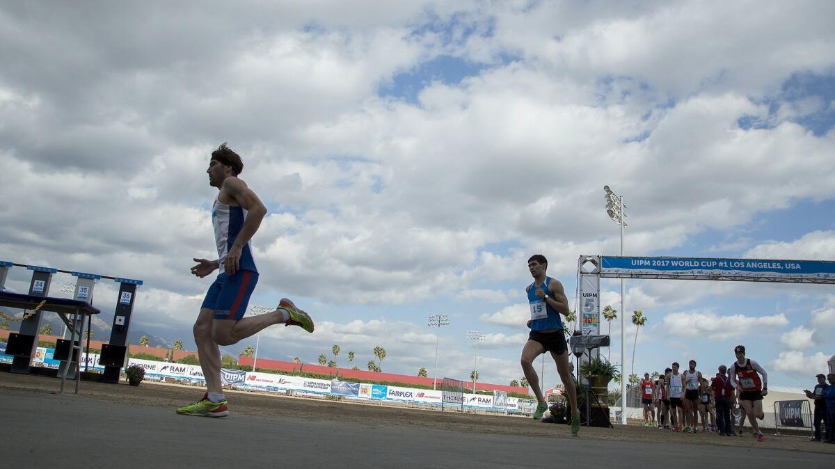 Competitors run to the shooting station during the run-shoot event at the Modern Pentathlon World Cup in Pomona. The modern pentathlon comprises five events -- swimming, fencing, cross-country running, shooting and show jumping.