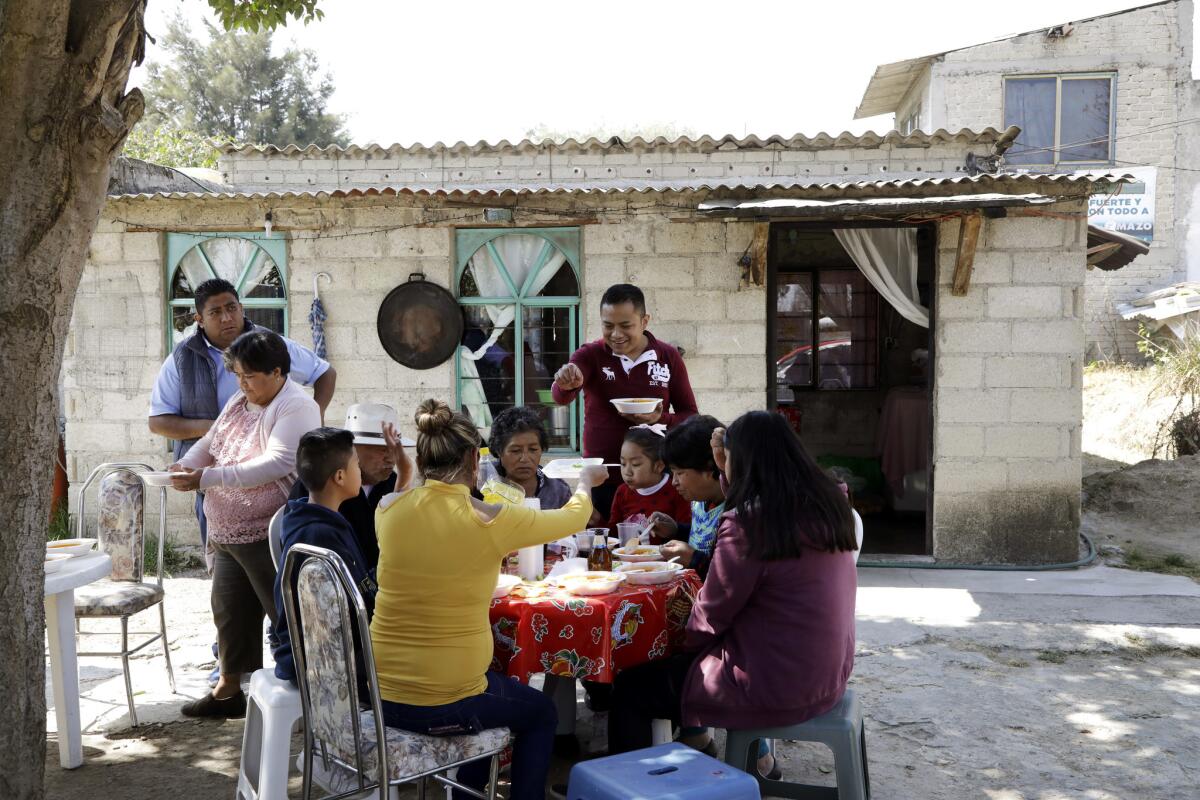 The family shares a meal after visiting the cemetery. (Katie Falkenberg / Los Angeles Times)