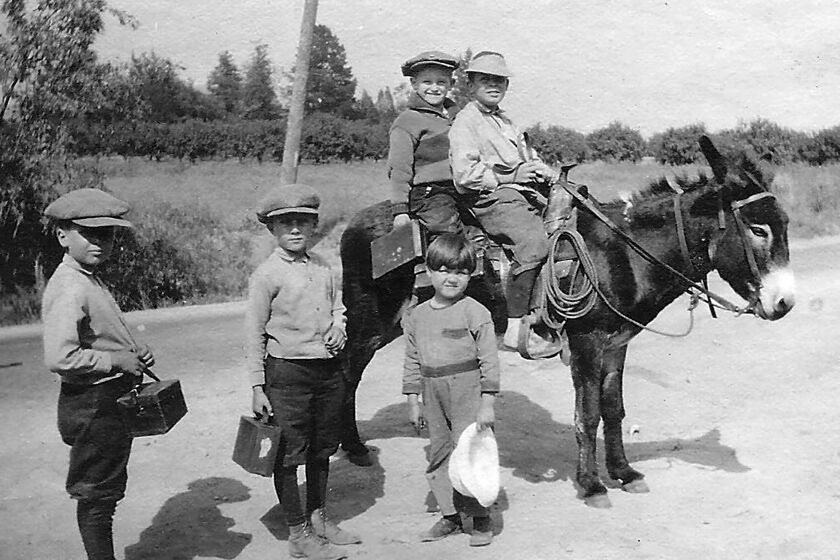 Children from the Moses family ride their donkey, Chili Beans, from their home on Palm Drive to school sometime in 1923. The photo is part of a virtual tour of Lanterman House being offered to students during the coronanvirus pandemic. (Courtesy of the Lanterman House Archives)