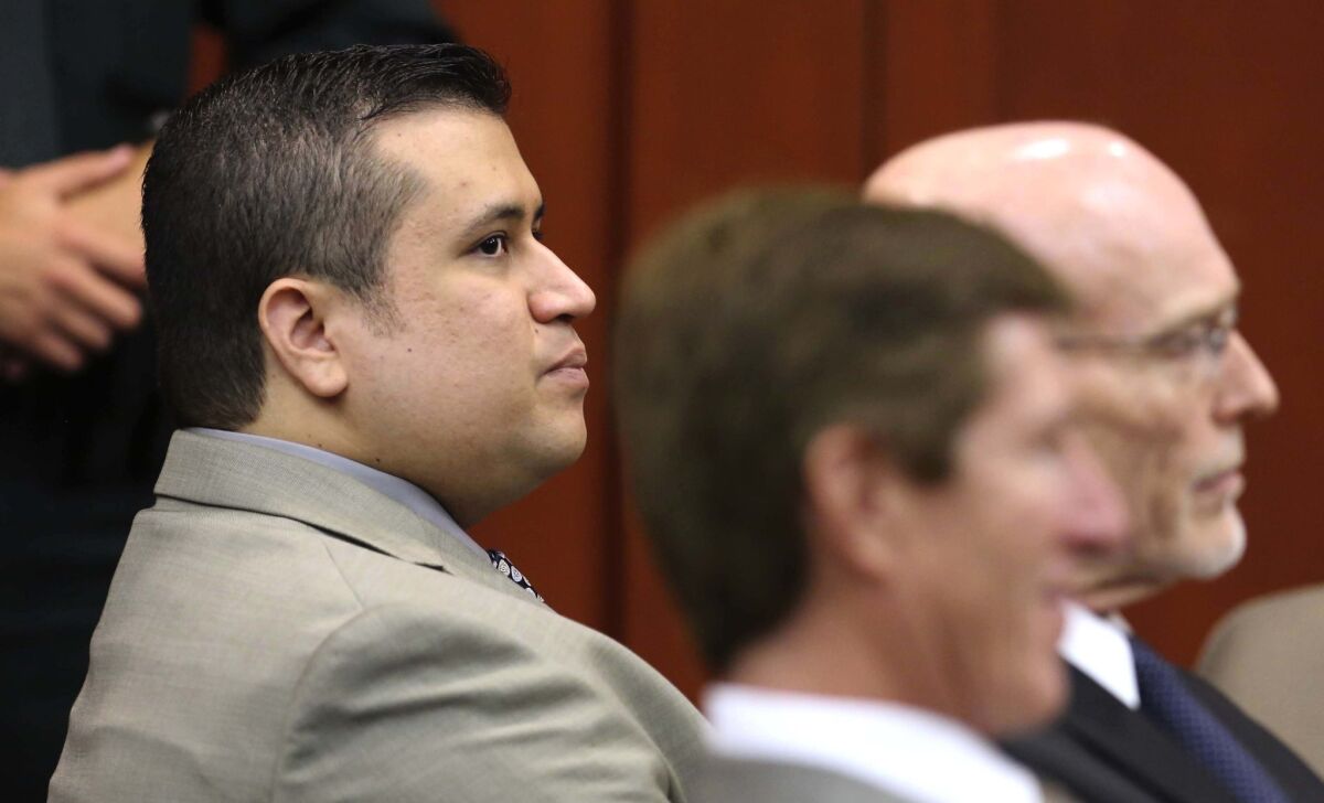 George Zimmerman, accused of murdering Trayvon Martin, appears in Seminole Circuit Court with his defense lawyers, in Sanford, Fla.