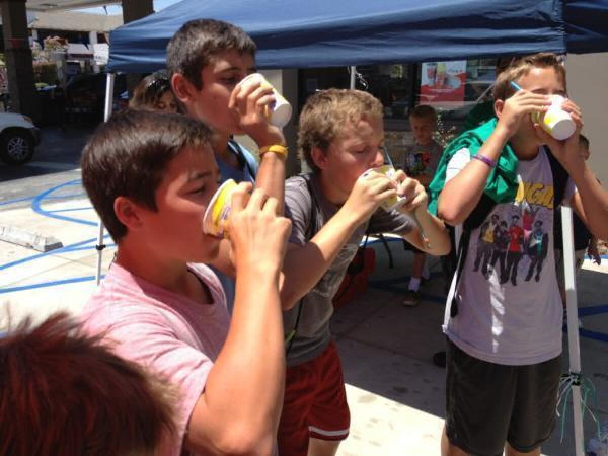 Kids compete in a Slurpee contest at the new store on Foothill Boulevard.
