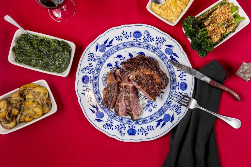 CULVER CITY, CALIFORNIA - June 7, 2019: An 18-ounce rib eye, with sides of german potatoes, broccolini, creamed corn, and creamed spinach at Dear John's, on Friday, June 7, 2019, at the resurrected iconic restaurant in Culver City. (Silvia Razgova / For The Times) 3081628_la-fo-dear-johns-addison