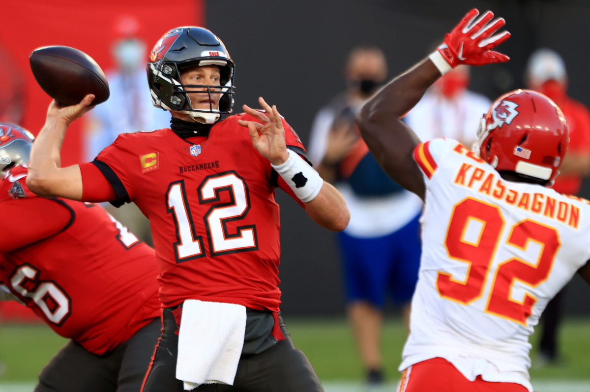 Tampa Bay Buccaneers quarterback Tom Brady looks to pass over Kansas City Chiefs defensive end Tanoh Kpassagnon.