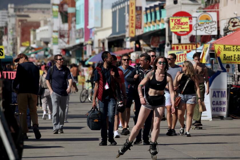 VENICE BEACH, CA - FEB. 9, 2022. People enjoy the sun along the Venice Beach Boardwalk as temperatures reached into the mid-80s in Southern California on Wednesday, Feb. 9, 2022. Warm weather is expected to continue through the Super Bowl weekend. (Luis Sinco / Los Angeles Times)