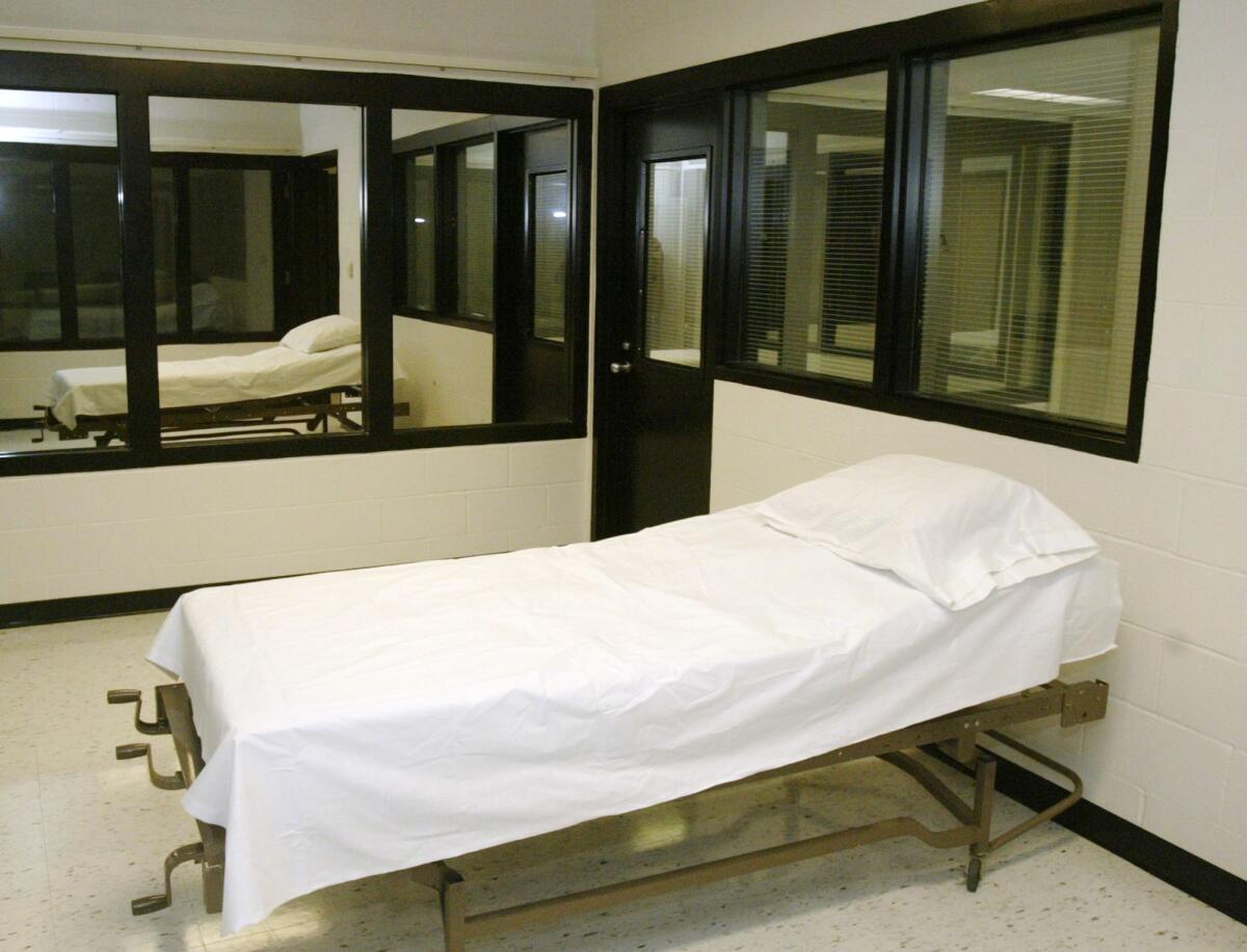 An empty cot sits in an execution chamber.