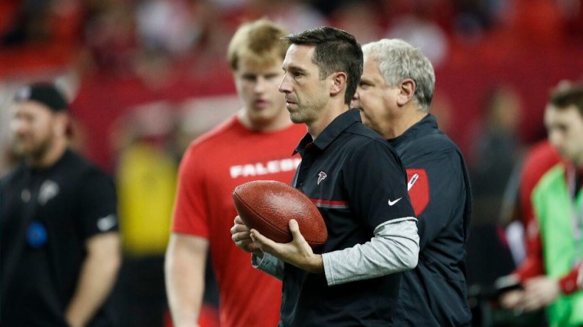 Falcons offensive coordinator Kyle Shanahan walks on the turf before the first half of a game against the 49ers in Atlanta on Dec. 18.