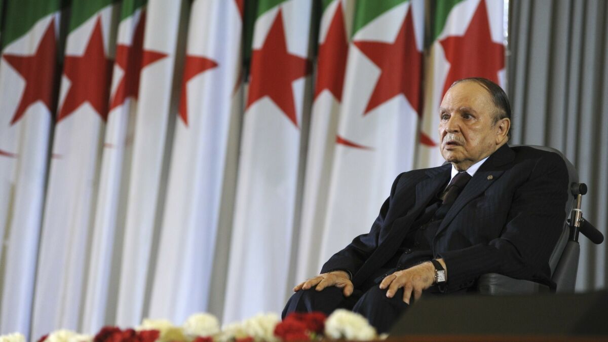 In this April 28, 2014, photo, Algerian President Abdelaziz Bouteflika sits in a wheelchair after taking the oath as president in Algiers, Algeria.
