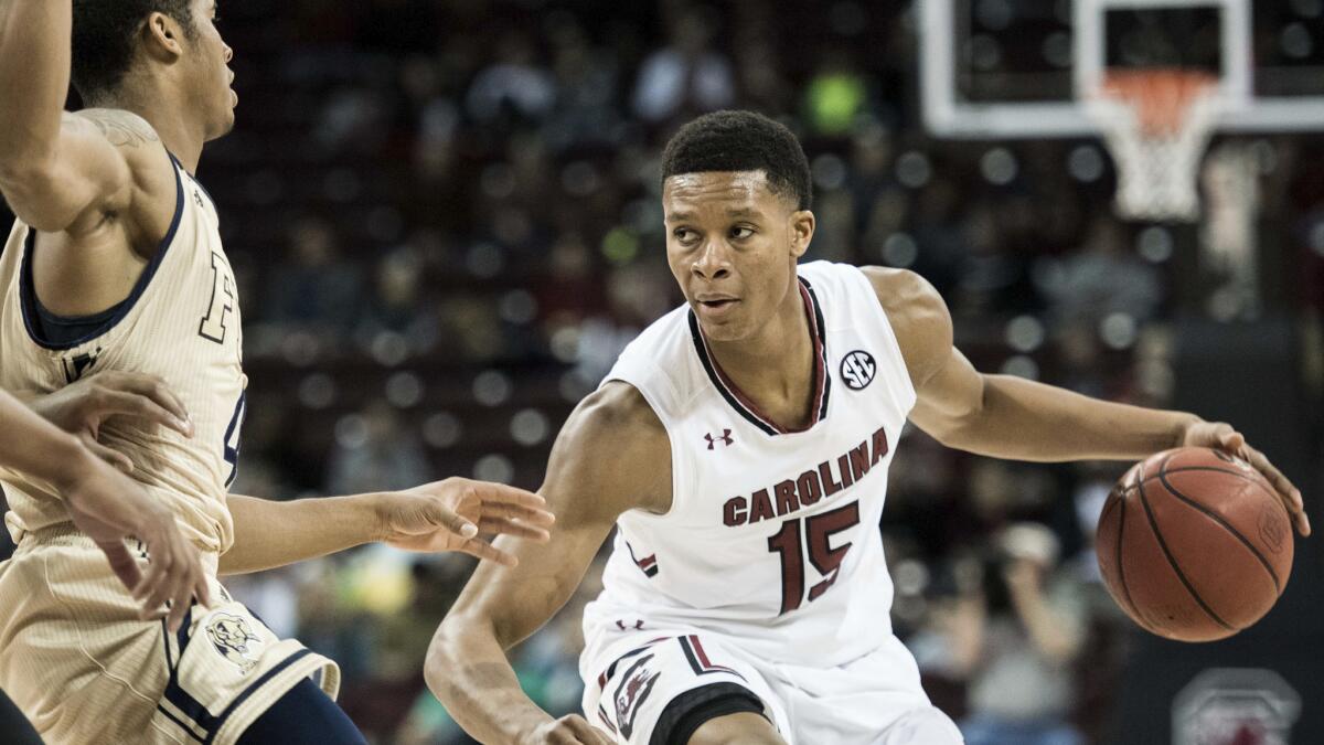 South Carolina guard P.J. Dozier looks to drive against Florida International forward Cameron Smith during the first half Sunday.