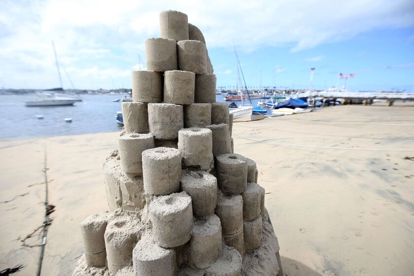 On the lighter side of the recent closures and life suspending activities, sandcastle artist Chris Crosson built a toilet paper tower entitled "Roll with it" on Balboa Island at Sapphire and the walkway.