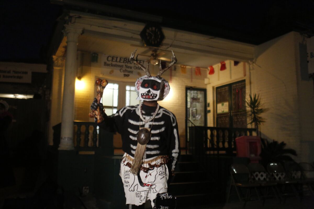 FILE - A member of the North Side Skull & Bone Gang starts the celebration with a wake up call for Mardi Gras at the Backstreet Cultural Museum, Feb. 9, 2016, in New Orleans. Ten months after Hurricane Ida damaged the museum celebrating New Orleans’ African American parading culture, it is reopening. (AP Photo/Brynn Anderson, File)