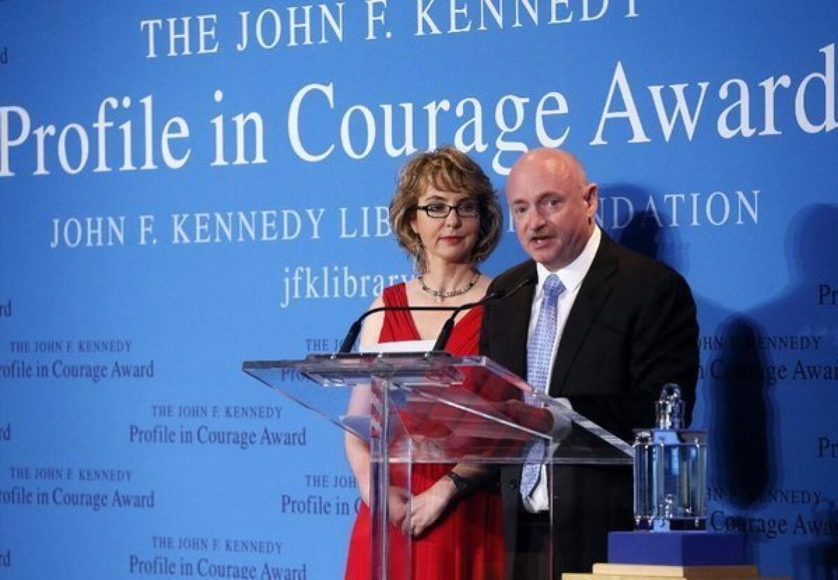 Former Rep. Gabrielle Giffords of Arizona received the John F. Kennedy Profile in Courage Award at the Kennedy Library in Boston. Speaking is Giffords' husband, Mark Kelly.