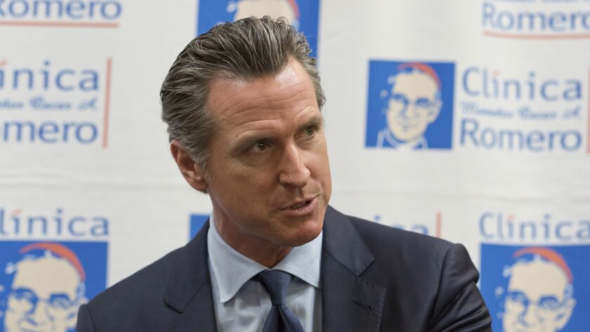 Gov. Gavin Newsom speaks during a round-table discussion with Central American community leaders at the Clinica Monsenor Oscar Romero in Los Angeles. His office has questioned the continued state service of a former agency head accused of nepotism.