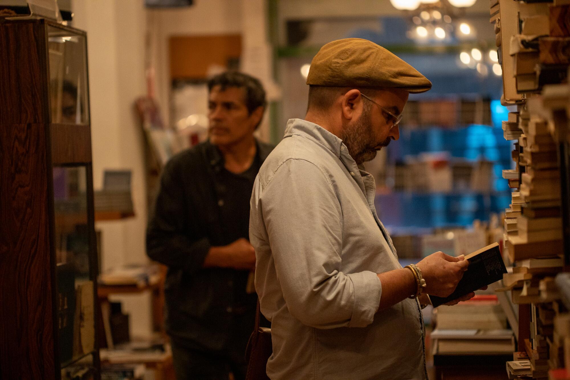 Actor Esai Morales, background, and author Eduardo Lalo on the set of "Simone."