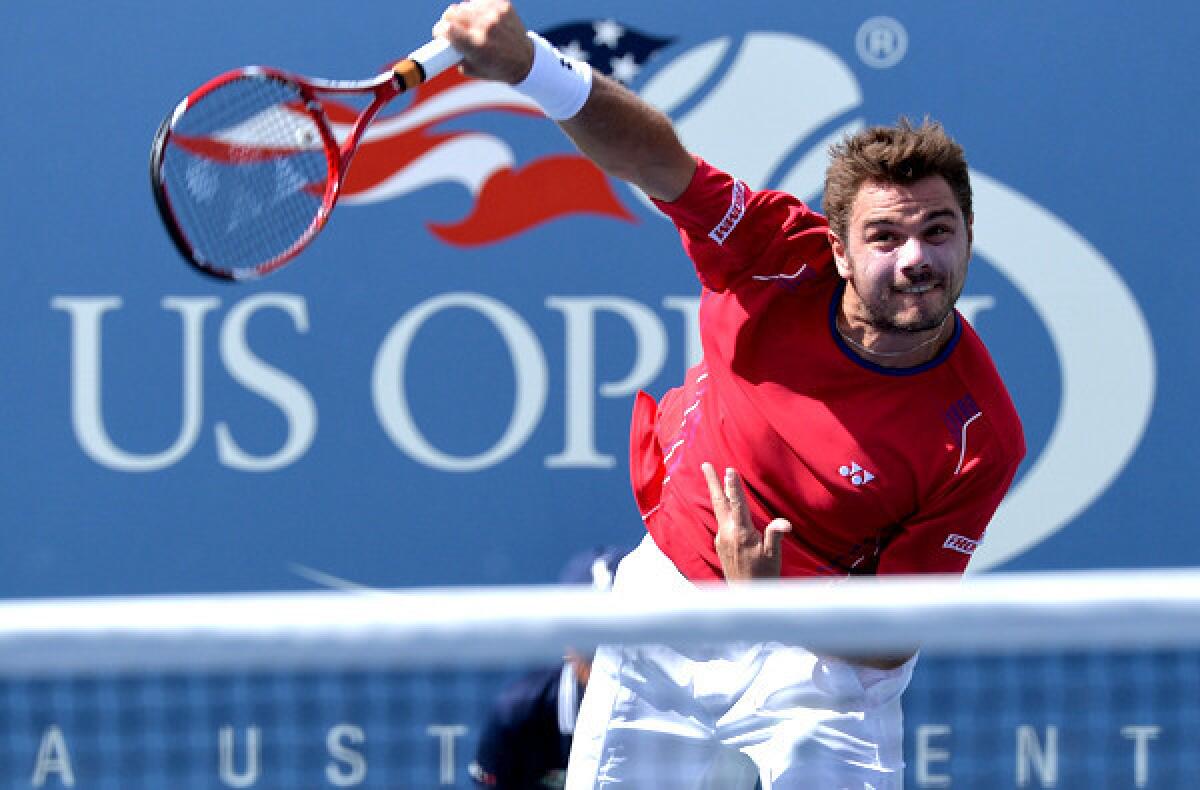 Stan Wawrinka serves against Andy Murray during their quarterfinal match Thursday at the U.S. Open.