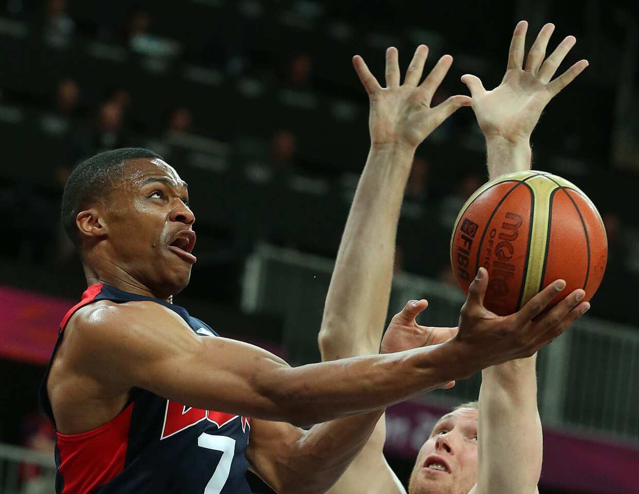Team USA's Russell Westbrook attempts a reverse layup in the first half against Lithuania in a men's basketball game at the Olympics.